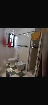 a bathroom with two sinks and a toilet and a shower at House Silvia & Nuno´s in Machico