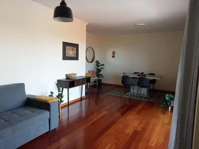 a living room with a couch and a table at Sunrise Apartment in Caniço
