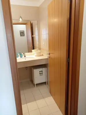 a bathroom with a sink and a mirror at Sunrise Apartment in Caniço