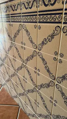a tiled wall with a design on it at Sunrise Apartment in Caniço