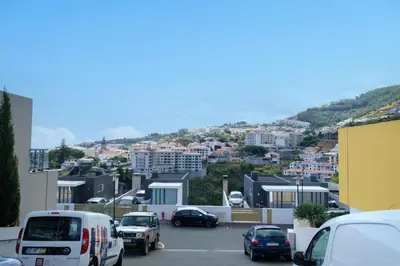 a city with cars parked in a parking lot at GuestReady - Charming Caniço Retreat in Caniço