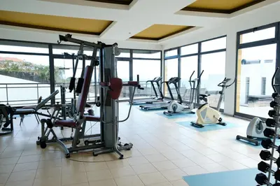 a gym with treadmills and elliptical machines at GuestReady - Charming Caniço Retreat in Caniço