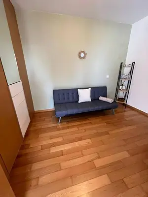 a blue couch in a room with a wooden floor at GuestReady - Charming Caniço Retreat in Caniço
