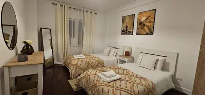 a hotel room with two beds and a mirror at A Pérola da Madeira by Rentallido in Funchal