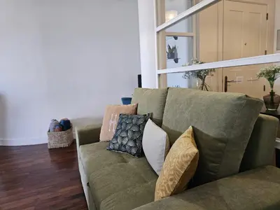 a green couch with pillows on it in a living room at A Pérola da Madeira by Rentallido in Funchal