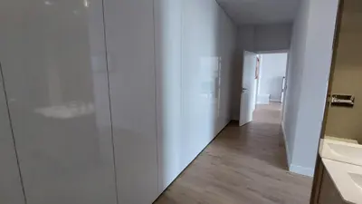 a hallway with white walls and wooden flooring in a room at Sol do Til Apartment in Funchal