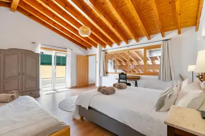 a bedroom with a large bed and a large window at Pita's House - Villa Sagres 2 in Sagres