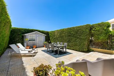 a patio with a table and chairs and a hedge at Pita's House - Villa Sagres 2 in Sagres