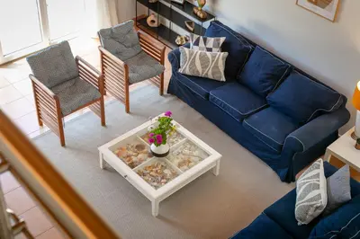 a living room with a blue couch and chairs at Pita's House - Villa Sagres 2 in Sagres
