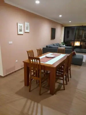 a living room with a table and chairs and a couch at Ocean Breeze Apartment in São Vicente
