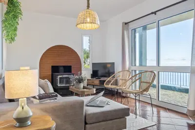 a living room with a couch and a table at Green Valley by Homie in Porto Moniz