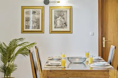 a dining room table with plates and bowls on it at Green Valley by Homie in Porto Moniz