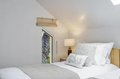 a bedroom with a white bed and a window at Green Valley by Homie in Porto Moniz