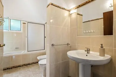 a bathroom with a sink and a toilet and a mirror at Green Valley by Homie in Porto Moniz