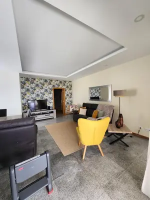 a living room with a yellow chair and a couch at Blue Horizon, Sea and Mountain view in Estreito da Calheta