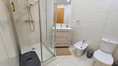 a bathroom with a shower and a toilet and a sink at Blue Horizon, Sea and Mountain view in Estreito da Calheta