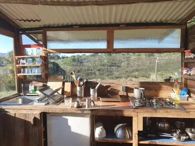 a kitchen with a counter with a sink and a window at Magical Treehouse in Lagos