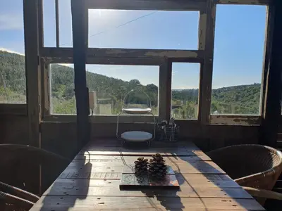 a table in a room with a large window at Magical Treehouse in Lagos