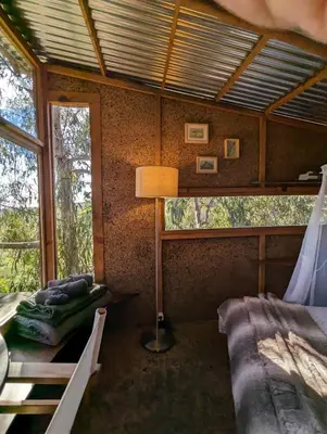 a room with two beds and a lamp in it at Magical Treehouse in Lagos
