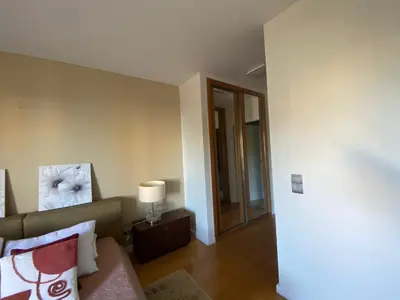 a living room with a couch and a table with a lamp at Seaview Nice&Easy - Free parking in Funchal