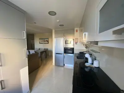 a kitchen with a black counter and a white refrigerator at Seaview Nice&Easy - Free parking in Funchal