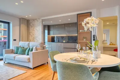 a kitchen and living room with a table and chairs at Becas Place, a Home in Madeira in Funchal