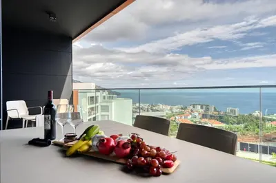 a plate of fruit on a table with a view at Becas Place, a Home in Madeira in Funchal