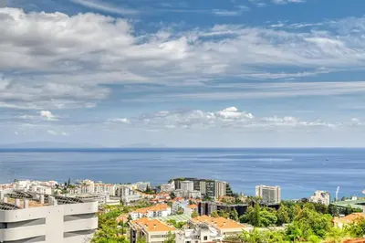 a view of a city with the ocean in the background at Becas Place, a Home in Madeira in Funchal