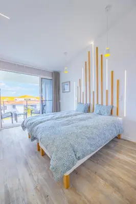 a bedroom with a large bed with a view of the ocean at Vista Oceano IV in Caniço