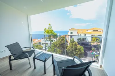 a balcony with chairs and a view of the ocean at Vista Oceano IV in Caniço