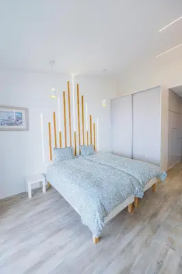 a bedroom with a large bed with a blue blanket at Vista Oceano IV in Caniço