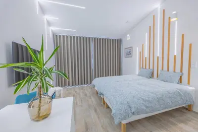 a bedroom with a bed and a potted plant at Vista Oceano IV in Caniço
