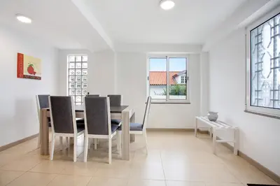a dining room with a table and chairs at Simão House in Calheta
