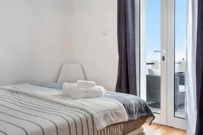 a bedroom with a large bed with two towels on it at Simão House in Calheta