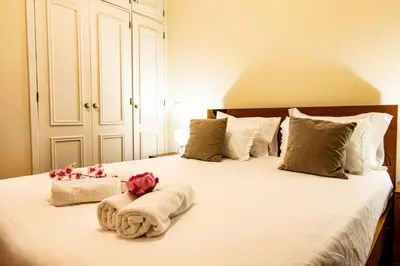 a bedroom with a bed with towels and flowers on it at GuestReady - Family-Friendly Haven in Funchal in Funchal