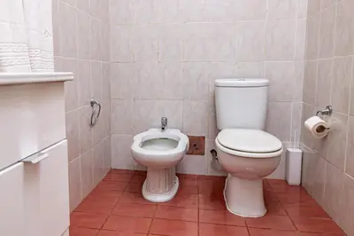 a bathroom with a toilet and a bidet at GuestReady - Family-Friendly Haven in Funchal in Funchal