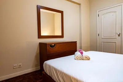a bedroom with a bed with two towels on it at GuestReady - Family-Friendly Haven in Funchal in Funchal
