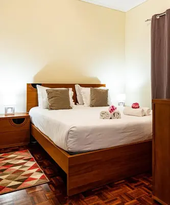 a bedroom with a large bed with white sheets at GuestReady - Family-Friendly Haven in Funchal in Funchal