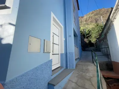 a blue building with a door on the side of it at Tides proprety - High tide in Paul do Mar