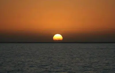 a sunset over the ocean with the sun in the sky at Tides proprety - High tide in Paul do Mar