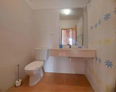 a bathroom with a sink and a toilet and a mirror at Desertrose in Porto Santo