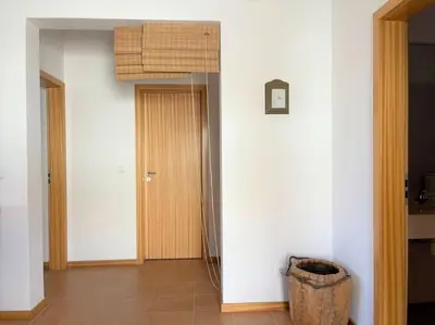 a room with a balcony with a large window at Desertrose in Porto Santo