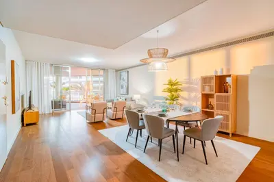 a dining room and living room with a table and chairs at Suite BM - 3 Pools-Gym-AC-Huge Balcony Sea View in Funchal