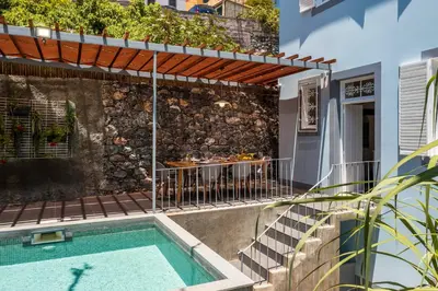 a house with a swimming pool and a patio at Villa Quebra Costas by An Island Apart in Funchal