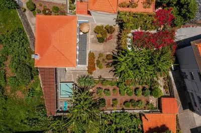 an overhead view of a house with a garden and a swimming pool at Villa Quebra Costas by An Island Apart in Funchal