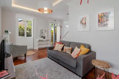 a living room with a gray couch and a tv at Villa Quebra Costas by An Island Apart in Funchal