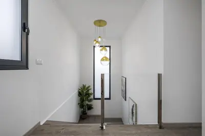 a room with a staircase with a light fixture at Landscape View by Homie in Canhas