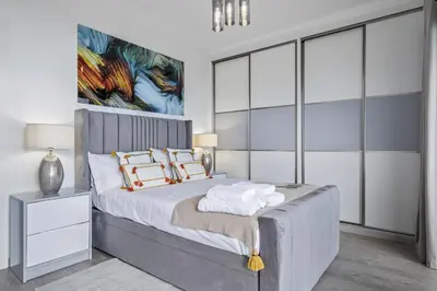 a bedroom with a large bed with glass walls at Landscape View by Homie in Canhas
