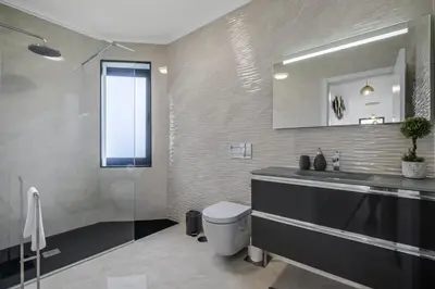 a bathroom with a sink and a toilet and a mirror at Landscape View by Homie in Canhas