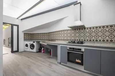 a kitchen with a sink and a stove top oven at Landscape View by Homie in Canhas